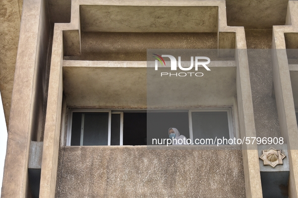 High school student wearing face mask look out of a window during the first day of the final exams, on June 21, 2020 in Cairo, Egypt. 