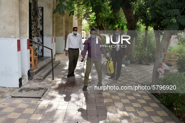 An employee spray disinfectant and sterilizes the school before starting high school exams to curb the spread of Coronavirus on June 21, 202...