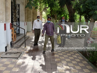 An employee spray disinfectant and sterilizes the school before starting high school exams to curb the spread of Coronavirus on June 21, 202...