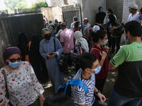 Hustle during the students ’exit from the Examination Committee during the first day of the high school exams in Giza Governorate, Egypt, on...