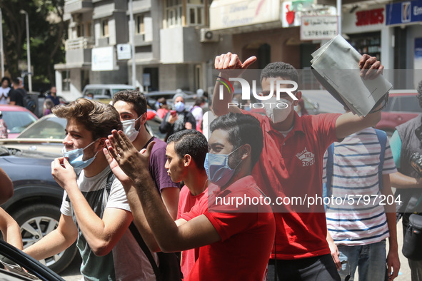 the students dance after exit from the Examination Committee during the first day of the high school exams in Giza Governorate, Egypt, on Ju...