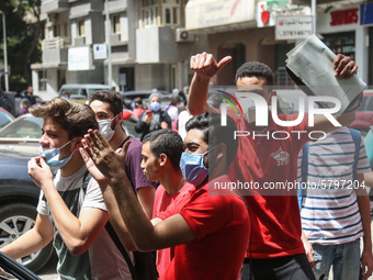 the students dance after exit from the Examination Committee during the first day of the high school exams in Giza Governorate, Egypt, on Ju...