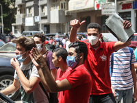 the students dance after exit from the Examination Committee during the first day of the high school exams in Giza Governorate, Egypt, on Ju...