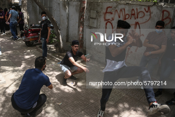 the students dance after exit from the Examination Committee during the first day of the high school exams in Giza Governorate, Egypt, on Ju...