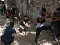 the students dance after exit from the Examination Committee during the first day of the high school exams in Giza Governorate, Egypt, on Ju...