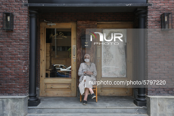 one of parents Sitting front of a restaurant while waiting the students exit outside the examination committee during the first day of high...