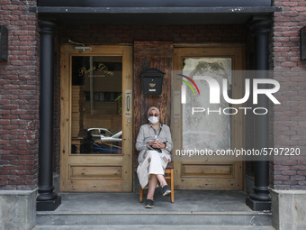 one of parents Sitting front of a restaurant while waiting the students exit outside the examination committee during the first day of high...