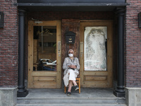 one of parents Sitting front of a restaurant while waiting the students exit outside the examination committee during the first day of high...