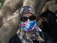 one of parents waiting the students exit outside the examination committee during the first day of high school exams in Giza Governorate, Eg...