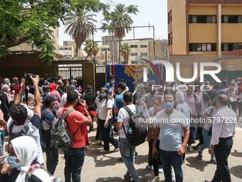 Hustle during the students ’exit from the Examination Committee during the first day of the high school exams in Giza Governorate, Egypt, on...