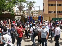 Hustle during the students ’exit from the Examination Committee during the first day of the high school exams in Giza Governorate, Egypt, on...