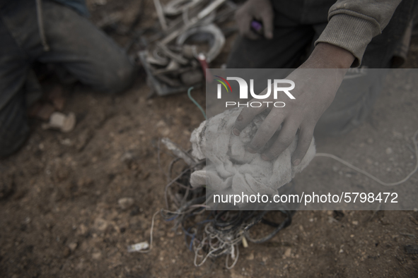 A boy preparing the stuff that he collected to melt them in Al-Mliha, Syria on September 2, 2019.  