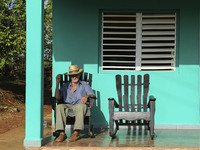 A farmer relaxes on his porch in Vinales, Cuba on May 7, 2015. Rocking chairs are a common site on the porches of most homes in Vinales. 

