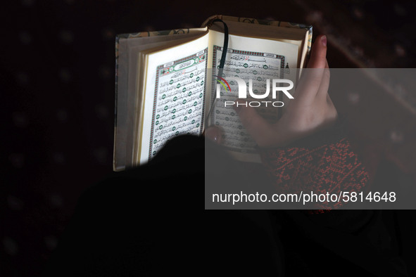 Girls keeping a safe distance from each other,attend a Koran memorization class as Palestinians ease the coronavirus disease (COVID-19) rest...