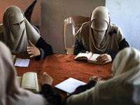 women keeping a safe distance from each other,attend a Koran memorization class as Palestinians ease the coronavirus disease (COVID-19) rest...