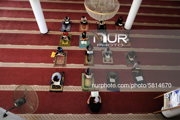  Boys keeping a safe distance from each other,attend a Koran memorization class as Palestinians ease the coronavirus disease (COVID-19) rest...