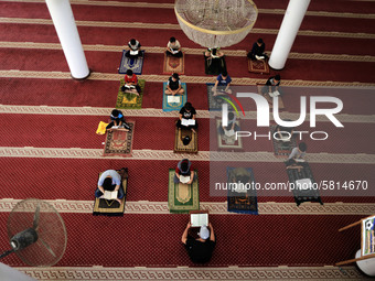  Boys keeping a safe distance from each other,attend a Koran memorization class as Palestinians ease the coronavirus disease (COVID-19) rest...