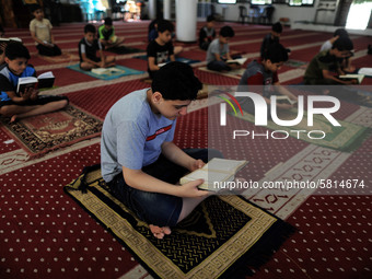  Boys keeping a safe distance from each other,attend a Koran memorization class as Palestinians ease the coronavirus disease (COVID-19) rest...