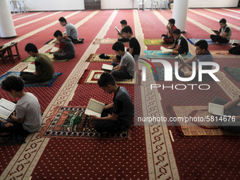  Boys keeping a safe distance from each other,attend a Koran memorization class as Palestinians ease the coronavirus disease (COVID-19) rest...