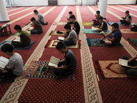  Boys keeping a safe distance from each other,attend a Koran memorization class as Palestinians ease the coronavirus disease (COVID-19) rest...