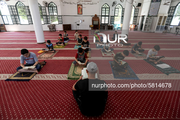  Boys keeping a safe distance from each other,attend a Koran memorization class as Palestinians ease the coronavirus disease (COVID-19) rest...