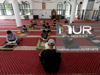  Boys keeping a safe distance from each other,attend a Koran memorization class as Palestinians ease the coronavirus disease (COVID-19) rest...