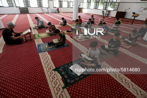  Boys keeping a safe distance from each other,attend a Koran memorization class as Palestinians ease the coronavirus disease (COVID-19) rest...