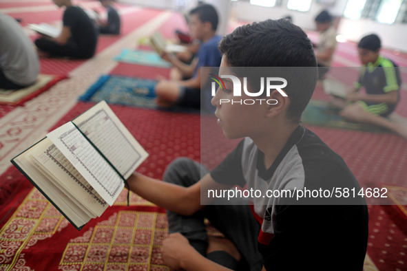  Boys keeping a safe distance from each other,attend a Koran memorization class as Palestinians ease the coronavirus disease (COVID-19) rest...