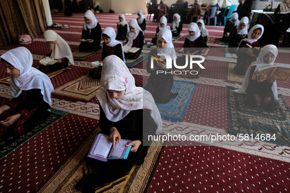 Girls keeping a safe distance from each other,attend a Koran memorization class as Palestinians ease the coronavirus disease (COVID-19) rest...