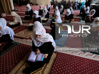 Girls keeping a safe distance from each other,attend a Koran memorization class as Palestinians ease the coronavirus disease (COVID-19) rest...