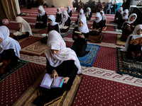 Girls keeping a safe distance from each other,attend a Koran memorization class as Palestinians ease the coronavirus disease (COVID-19) rest...