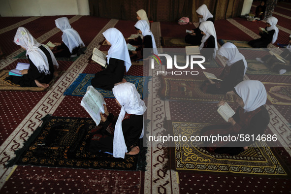 Girls keeping a safe distance from each other,attend a Koran memorization class as Palestinians ease the coronavirus disease (COVID-19) rest...