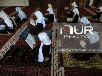 Girls keeping a safe distance from each other,attend a Koran memorization class as Palestinians ease the coronavirus disease (COVID-19) rest...