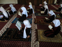 Girls keeping a safe distance from each other,attend a Koran memorization class as Palestinians ease the coronavirus disease (COVID-19) rest...