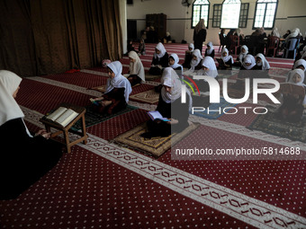 Girls keeping a safe distance from each other,attend a Koran memorization class as Palestinians ease the coronavirus disease (COVID-19) rest...