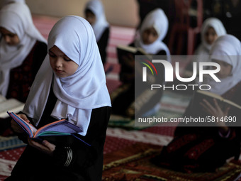 Girls keeping a safe distance from each other,attend a Koran memorization class as Palestinians ease the coronavirus disease (COVID-19) rest...