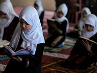 Girls keeping a safe distance from each other,attend a Koran memorization class as Palestinians ease the coronavirus disease (COVID-19) rest...