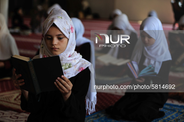 Girls keeping a safe distance from each other,attend a Koran memorization class as Palestinians ease the coronavirus disease (COVID-19) rest...