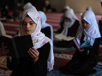 Girls keeping a safe distance from each other,attend a Koran memorization class as Palestinians ease the coronavirus disease (COVID-19) rest...