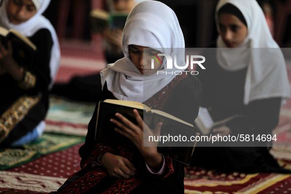 Girls keeping a safe distance from each other,attend a Koran memorization class as Palestinians ease the coronavirus disease (COVID-19) rest...