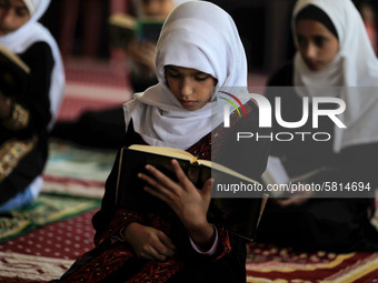 Girls keeping a safe distance from each other,attend a Koran memorization class as Palestinians ease the coronavirus disease (COVID-19) rest...