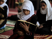 Girls keeping a safe distance from each other,attend a Koran memorization class as Palestinians ease the coronavirus disease (COVID-19) rest...