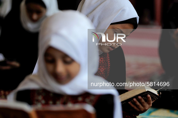 Girls keeping a safe distance from each other,attend a Koran memorization class as Palestinians ease the coronavirus disease (COVID-19) rest...