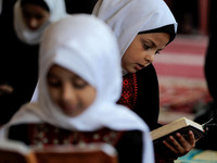 Girls keeping a safe distance from each other,attend a Koran memorization class as Palestinians ease the coronavirus disease (COVID-19) rest...