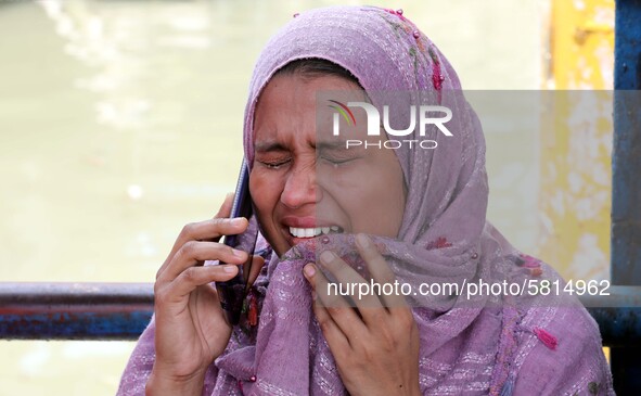 Relatives of a victim cry after recovered bodies of victims following the Launch capsized in Buriganga River in Dhaka. At least 30 people di...