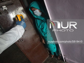 A healthcare worker checks the temperature of a woman during a medical check-up in Mumbai, India on July 01, 2020. India is the fourth worst...