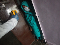 A healthcare worker checks the temperature of a woman during a medical check-up in Mumbai, India on July 01, 2020. India is the fourth worst...