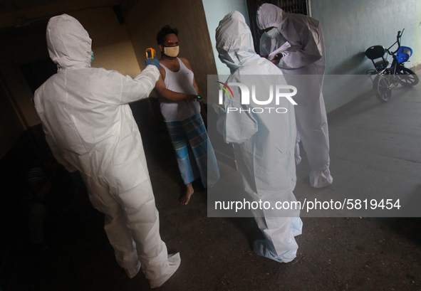 A healthcare worker checks the temperature of a man during a medical check-up in Mumbai, India on July 01, 2020. India is the fourth worst-h...