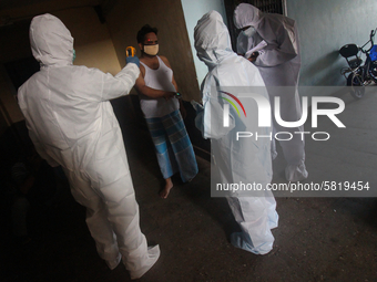 A healthcare worker checks the temperature of a man during a medical check-up in Mumbai, India on July 01, 2020. India is the fourth worst-h...