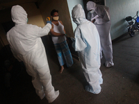 A healthcare worker checks the temperature of a man during a medical check-up in Mumbai, India on July 01, 2020. India is the fourth worst-h...